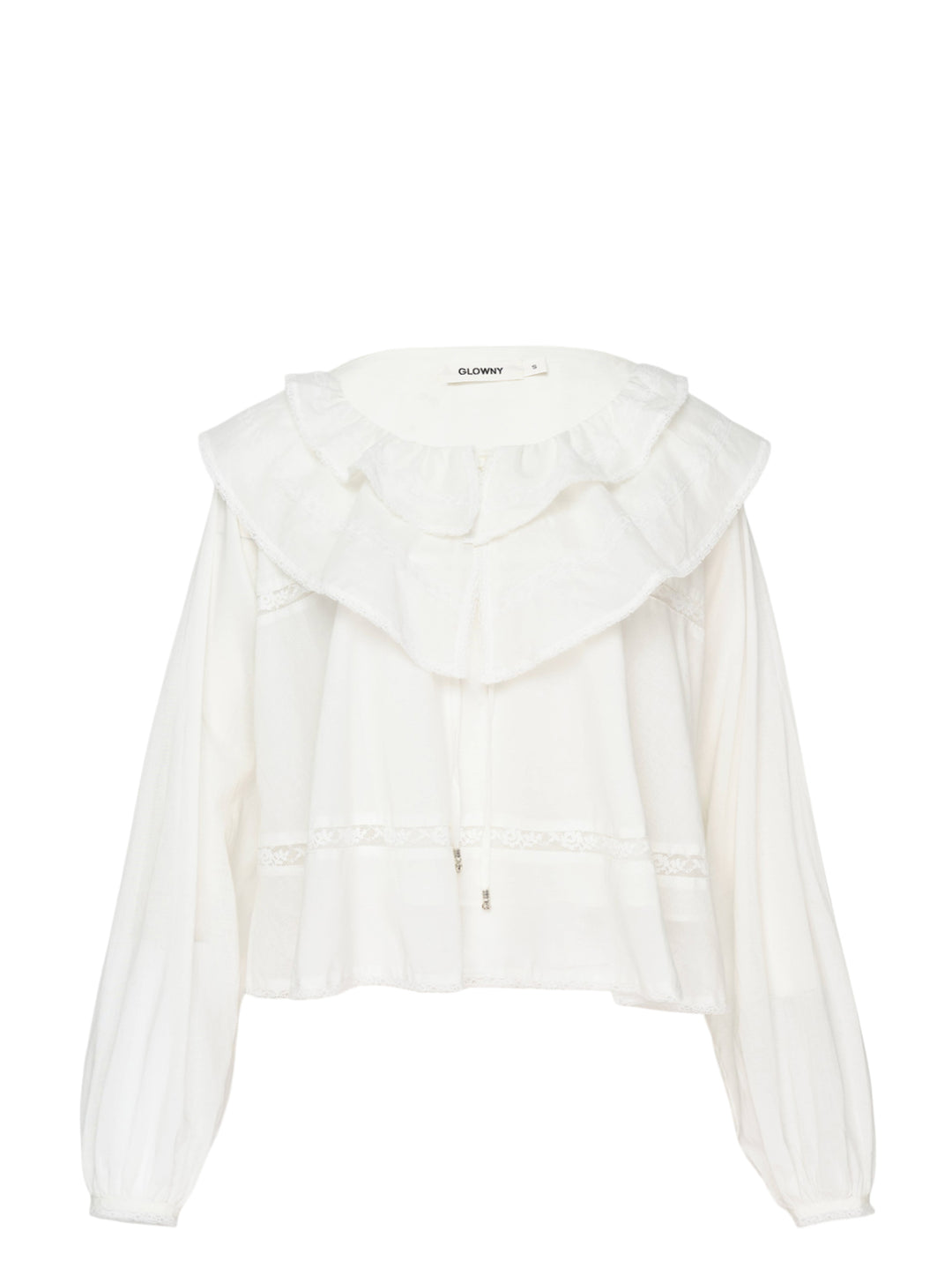 Glowny Mallow Lace Blouse in white with oversized double-tiered ruffle collar, lace trim inserts at the bodice and waist, and billowy long sleeves with elasticated cuffs