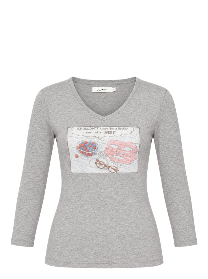 Glowny Off Duty Girl heather grey V-neck three-quarter sleeve tee with a comic-strip graphic print featuring a pink face mask, a bowl of berries, spectacles, and the text 'SHOULDN'T there be a lipstick named after ME?'