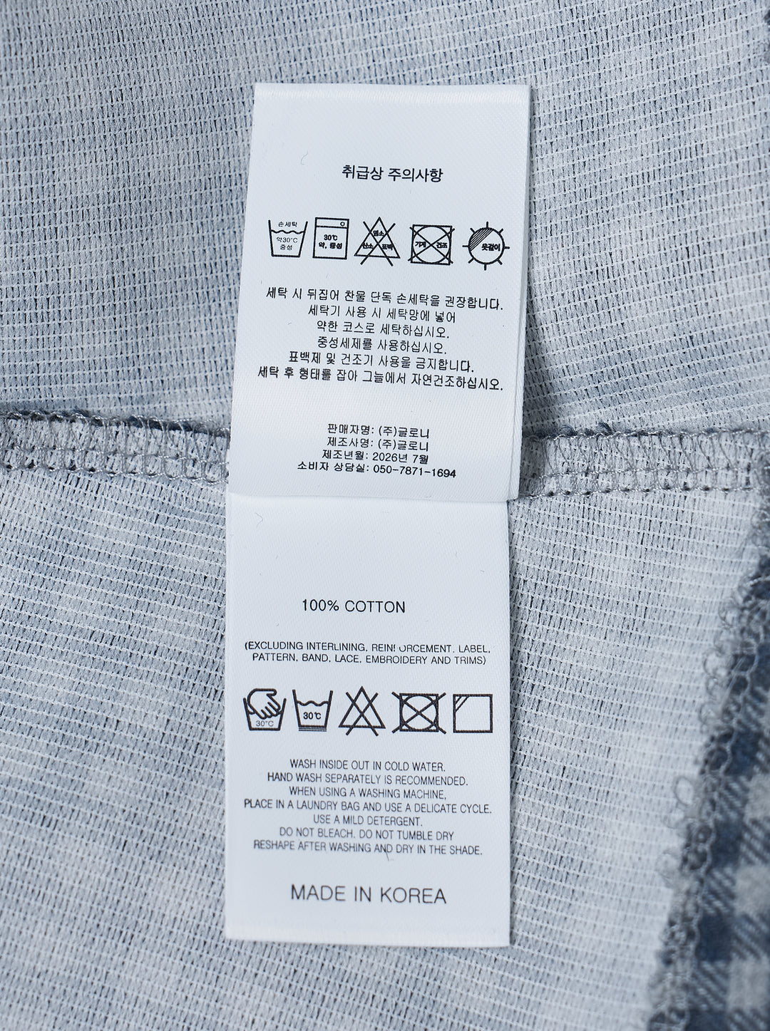 Glowny Polly Wrap Skorts in navy and white gingham check, showing structured waistband with button fastening and welt back pocket, laid flat on white background - view 3