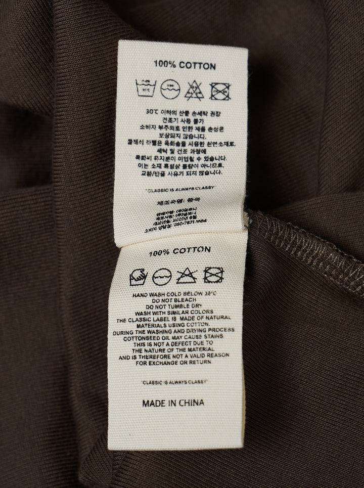 Glowny Classic Mini Skirt in dark espresso brown jersey with a low-rise waistband, A-line silhouette, and woven Glowny label at the hem - view 3