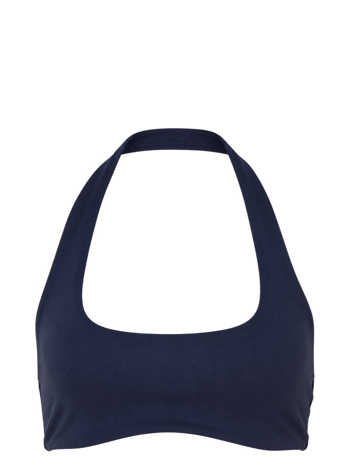 Navy halter-neck bralette from Nike X Jacquemus with a scoop front neckline and open back, shown flat against a white background