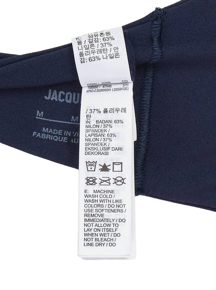 Navy halter-neck bralette from Nike X Jacquemus with a scoop front neckline and open back, shown flat against a white background - view 3