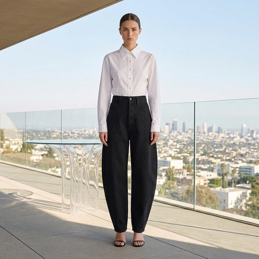 Alaïa black denim round pants with a high waist, five-pocket design and sculpted curved leg, shown from the front - lifestyle