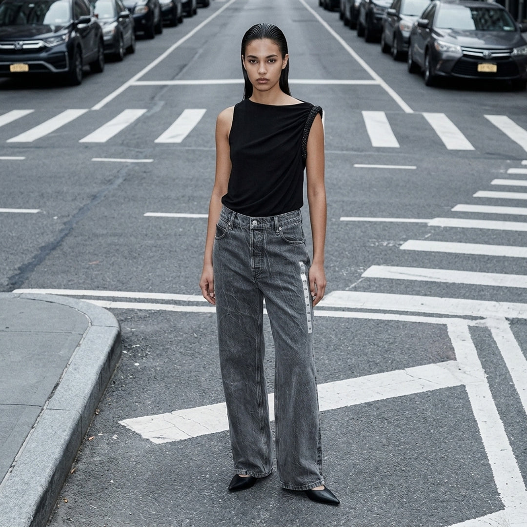 Alexander Wang unisex wide-leg jeans in washed charcoal denim with woven AW flasher label detail, front view - lifestyle