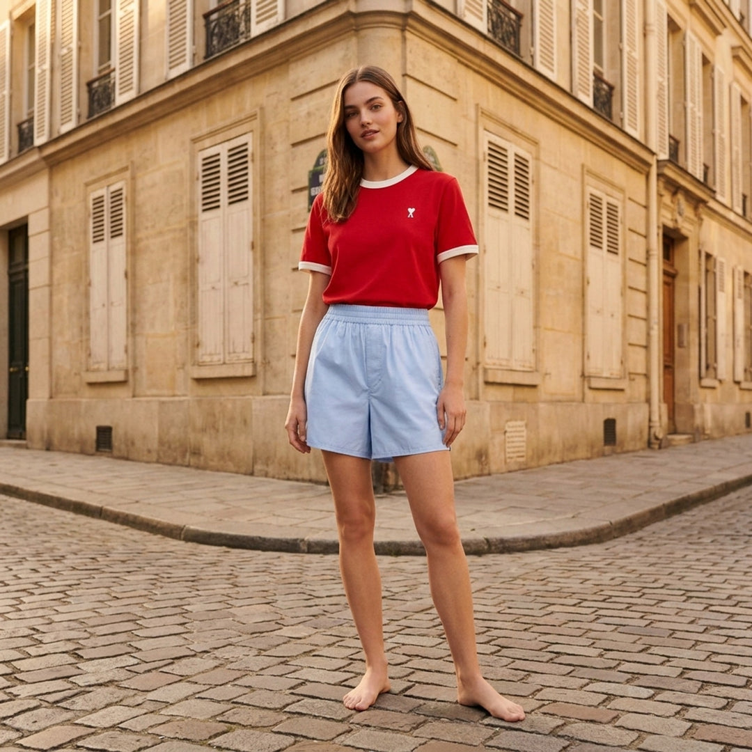 Ami Alexandre Mattiussi forest green bicolor ringer tee with cream contrast collar and cuff trim, featuring the embroidered Ami de Cœur logo at the chest - lifestyle