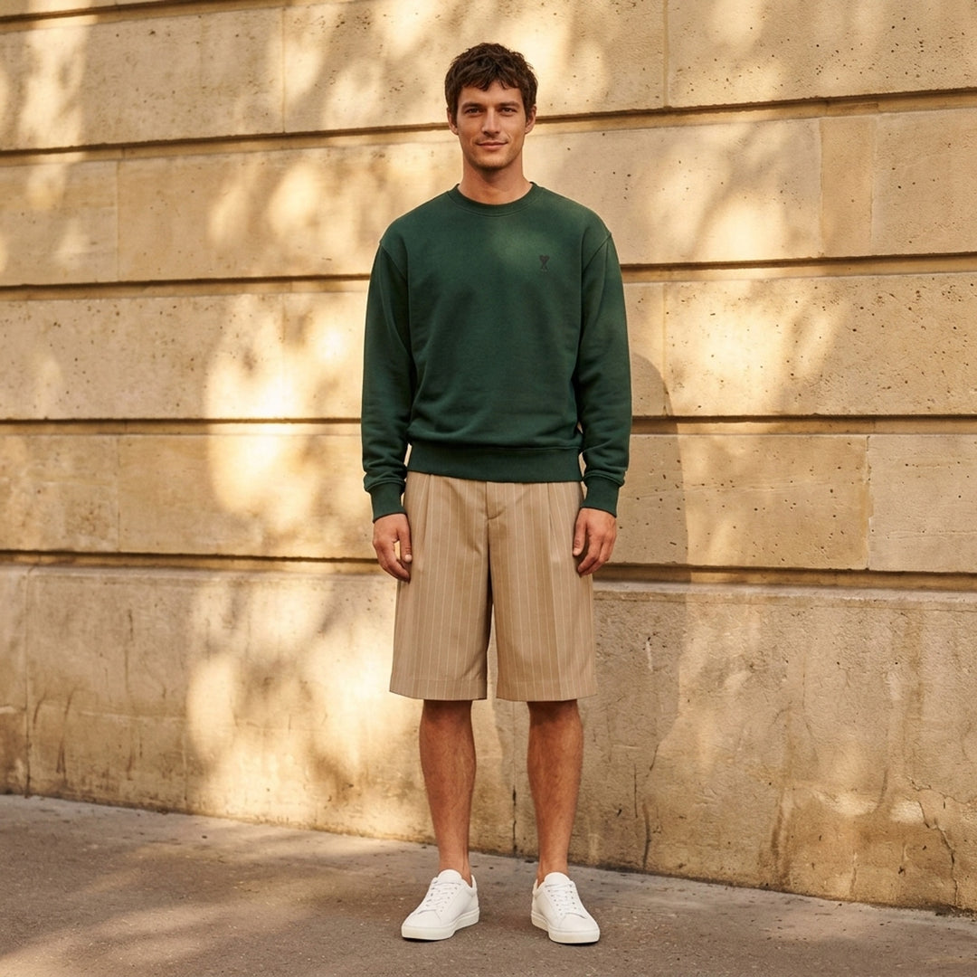 AMI forest green crewneck sweatshirt with ribbed trim and a small embroidered Ami de Coeur logo at the chest - lifestyle