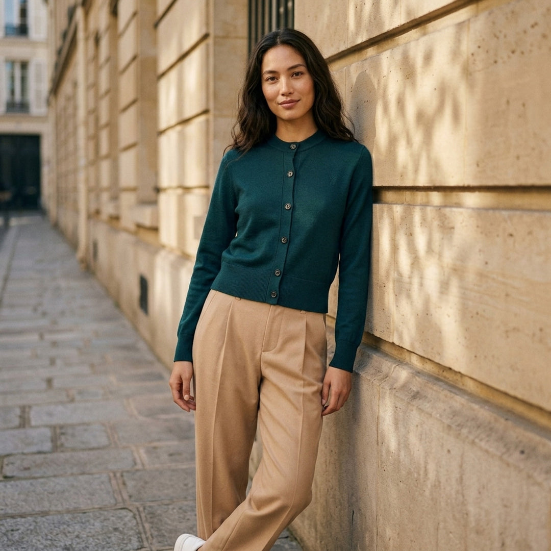 AMI Quota crewneck cardigan in deep forest green with black buttons, ribbed hem and cuffs, and a tonal embroidered heart logo on the chest - lifestyle