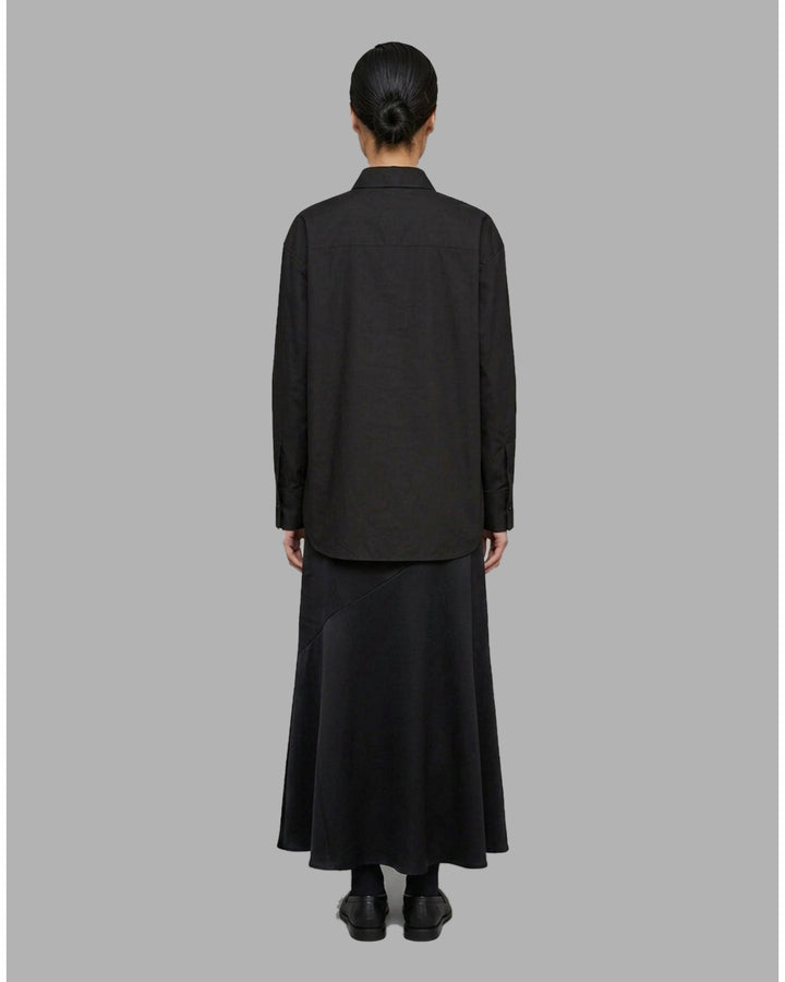 Ivory matte acetate-mix maxi skirt with a diagonal seam and flared hem, shown from the front - back