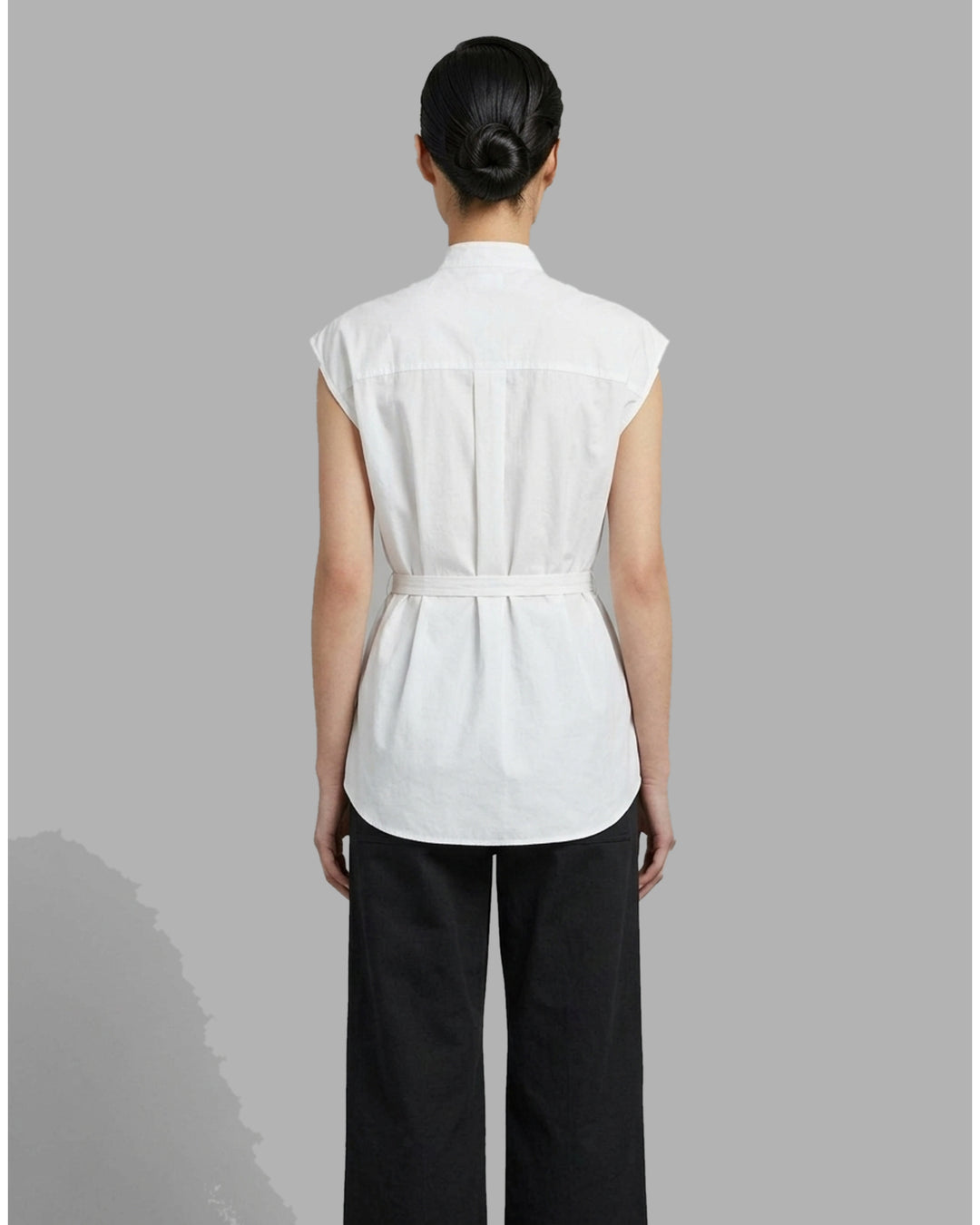 Black sleeveless cotton shirt with pintucked bib front, mandarin collar and self-fabric waist tie - back