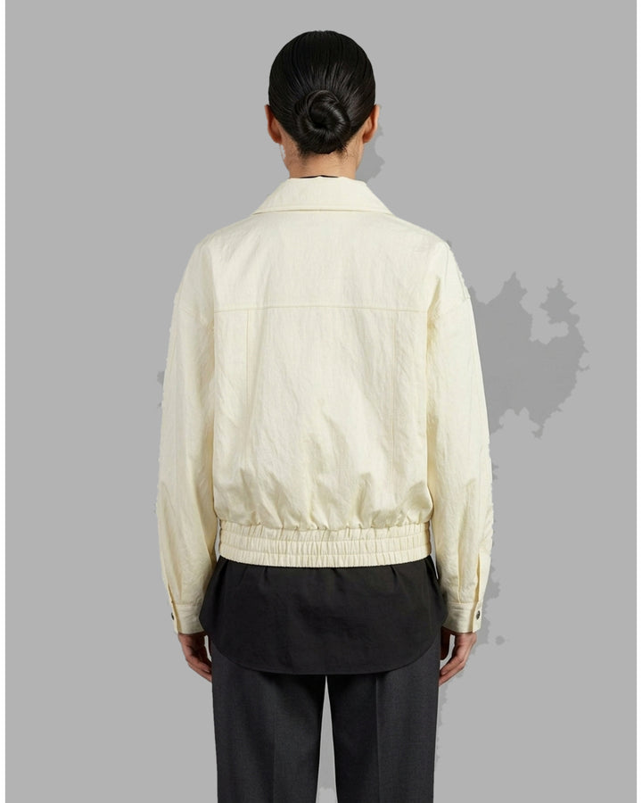 Cream cropped bomber jacket with stand collar, flap chest pockets, metal snap buttons and elasticated hem by Club21 Collection - back