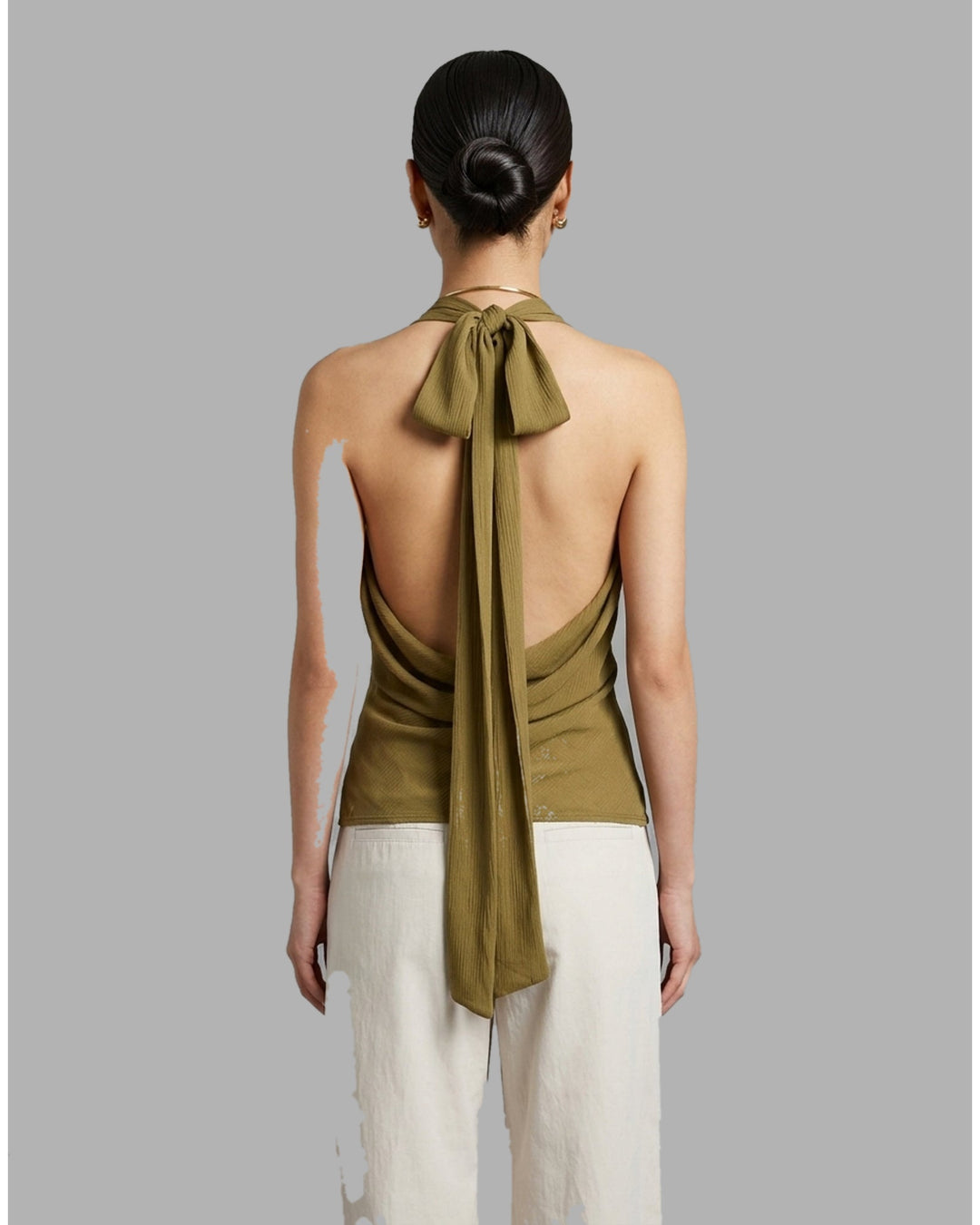 Black sleeveless halter top in crinkled silk-blend fabric with a scooped neckline and self-tie open back - back