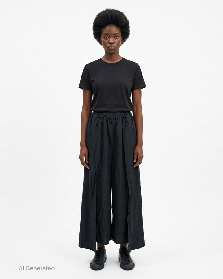 Comme des Garçons Comme des Garçons relaxed wide leg black drawstring pants with elasticated waistband and voluminous crinkled drape, shown flat on white background - front