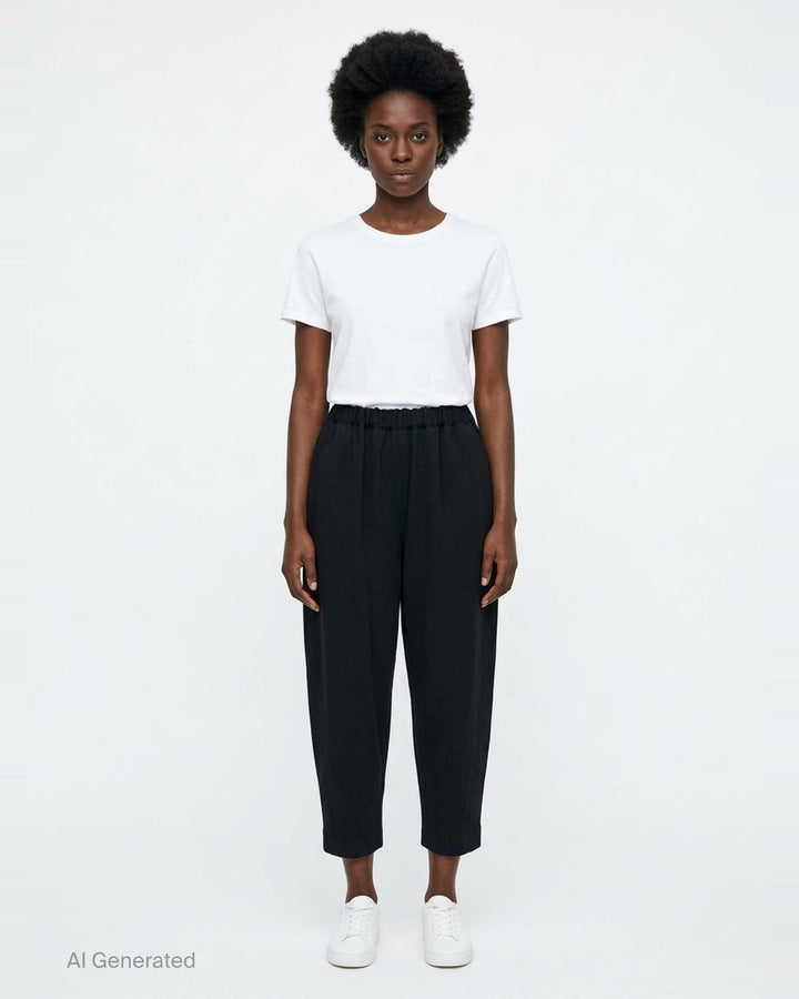 Comme des Garçons Comme des Garçons black tapered cocoon pants with elasticated ruched waistband and cropped narrow hem, front view - front