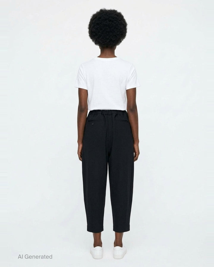 Comme des Garçons Comme des Garçons black tapered cocoon pants with elasticated ruched waistband and cropped narrow hem, front view - back