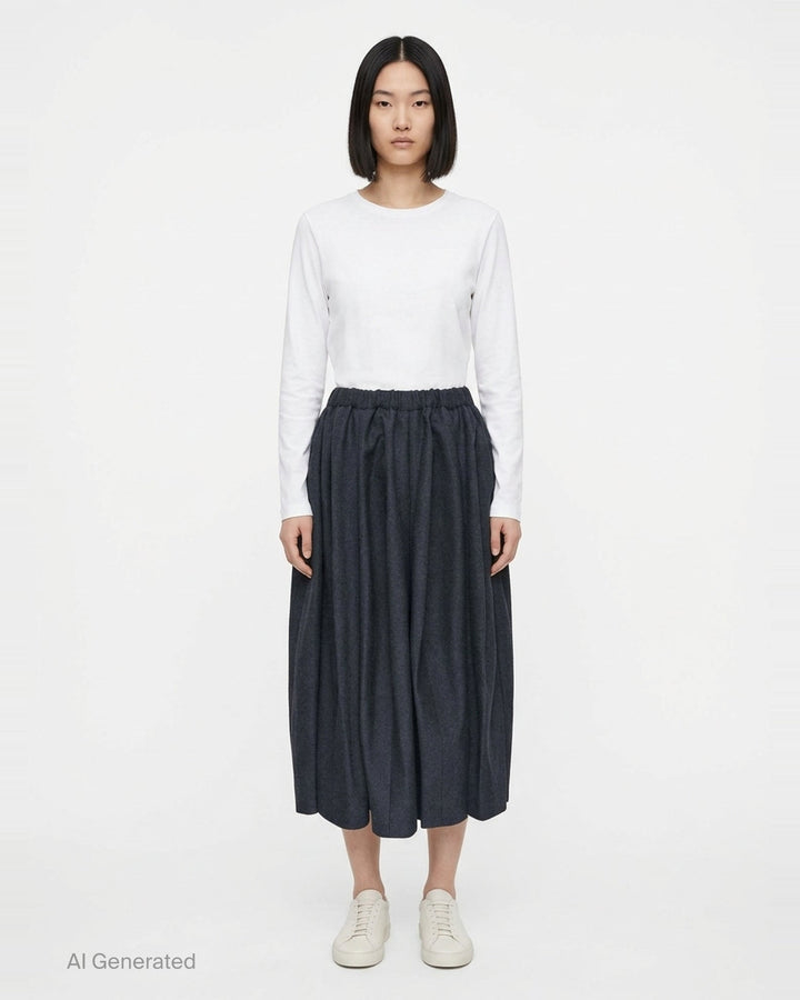 Comme des Garçons Comme des Garçons voluminous cocoon midi skirt in charcoal grey with elasticated drawstring waist and gathered sculptural silhouette, displayed flat on white background - front