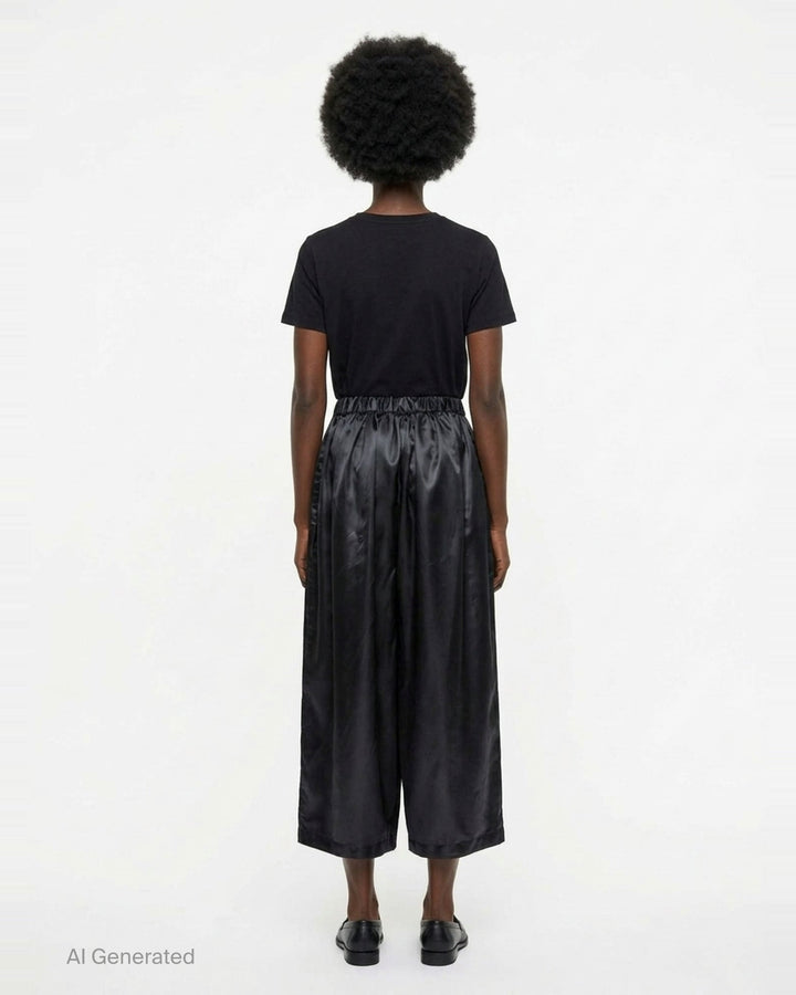 Comme des Garçons Girl black polyester satin wide-leg pants with elasticated ruched waistband and voluminous gathered silhouette, front view - back