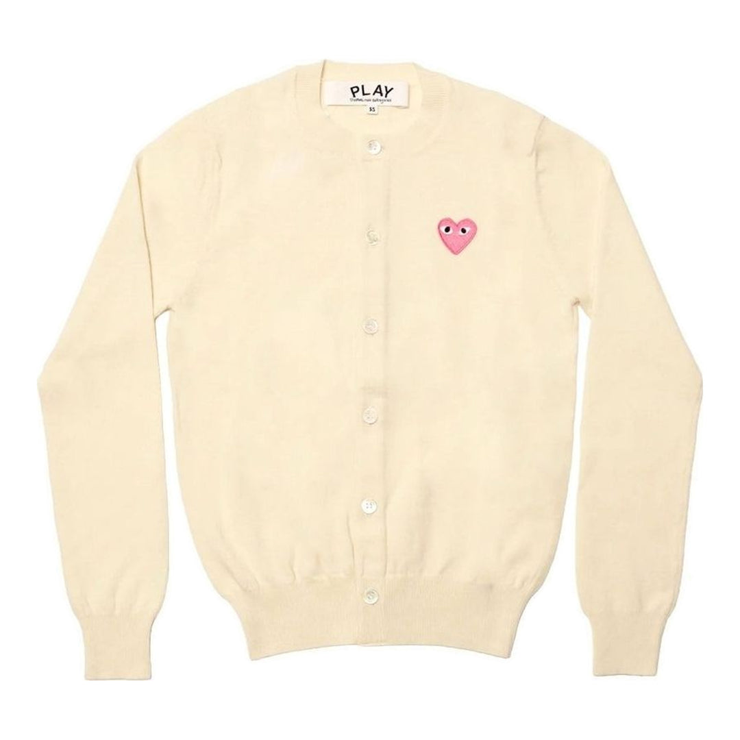 Comme des Garçons PLAY black round neck cardigan with embroidered pink heart emblem patch and button-through front fastening, flat lay view - packshot