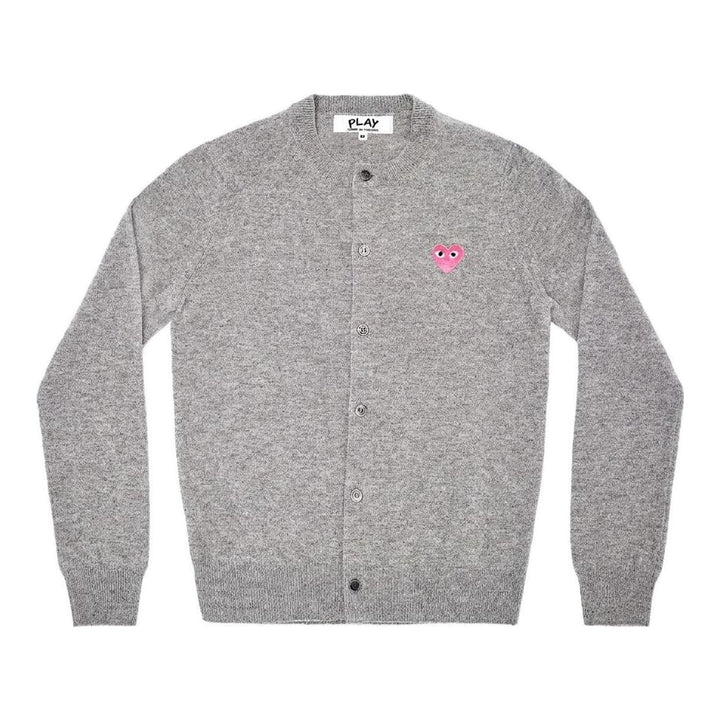 Comme des Garçons PLAY black round neck cardigan with embroidered pink heart emblem patch and button-through front fastening, flat lay view - packshot