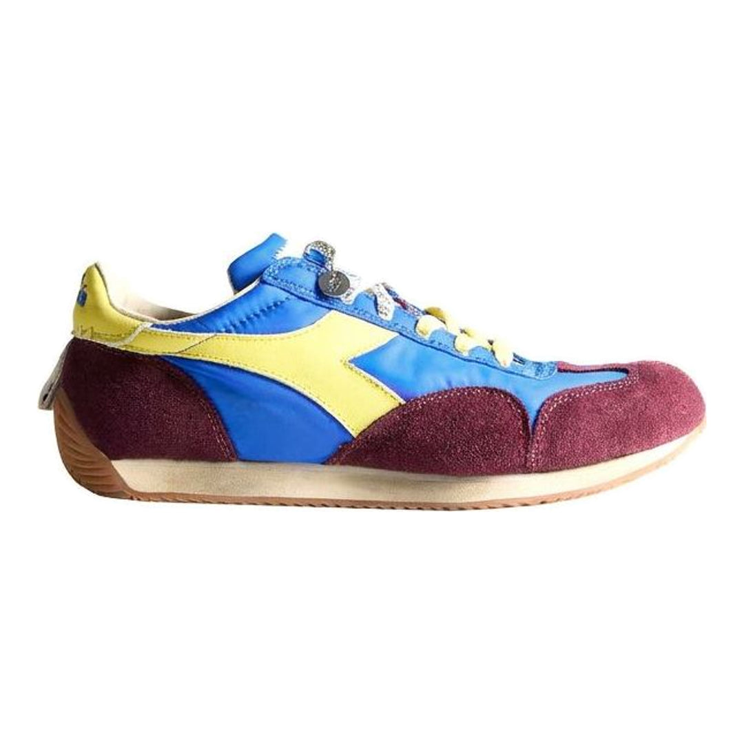 Diadora x JW Anderson retro nylon sneaker in blue with khaki suede overlays, coral laces, and a white Diadora logo stripe, set against a white background - packshot