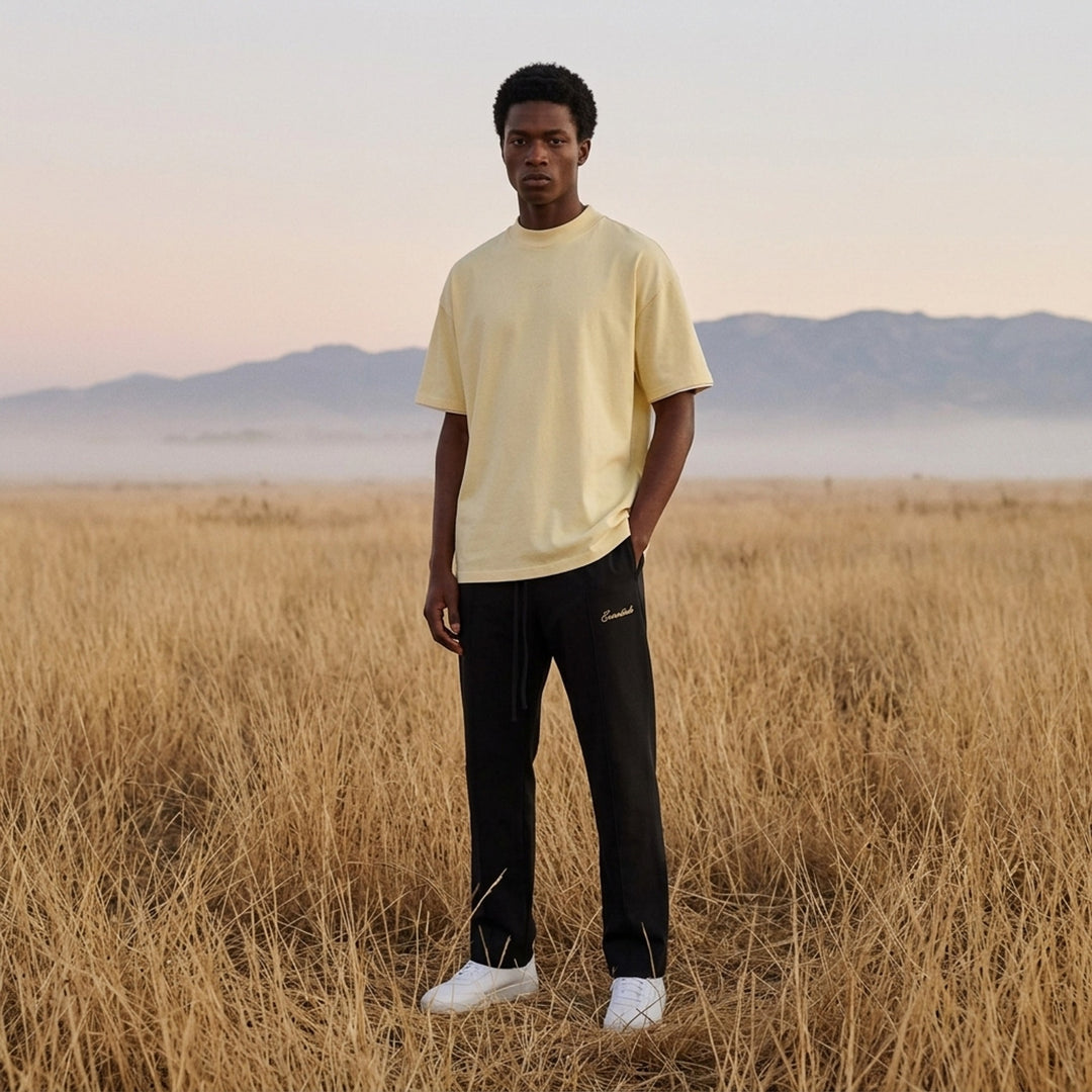 Fear of God ESSENTIALS Classic Double Layer Tee in black with white undertee at the neckline and hem and tonal embroidered logo at the chest - lifestyle