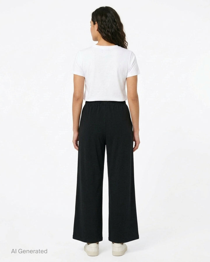 Glowny Button Fly Wide Leg Pants in black, featuring an elasticated waistband, three-button fly placket, wide-leg silhouette, and woven brand label tab at the hip - back