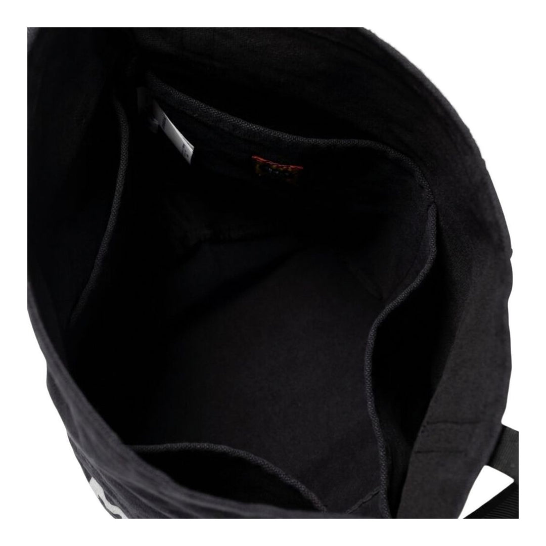 Human Made Balloon Tote bag in black canvas with bold collegiate logo print and dual top handles, shown at a three-quarter angle - packshot