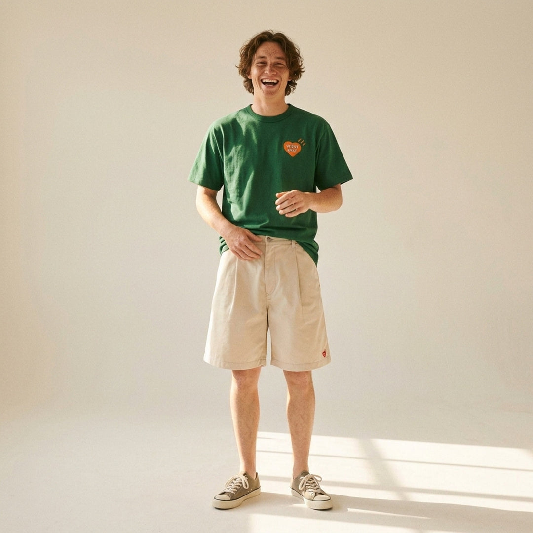 Human Made brown short-sleeve graphic T-shirt with an orange heart logo print at the chest and a red woven label at the neck - lifestyle