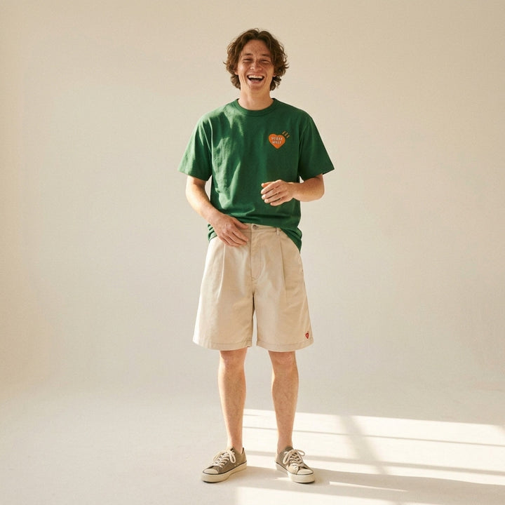 Human Made brown short-sleeve graphic T-shirt with an orange heart logo print at the chest and a red woven label at the neck - lifestyle