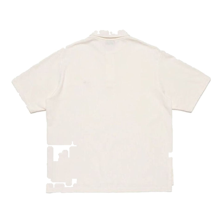 Human Made Short Sleeve Polo Shirt in navy piqué cotton with embroidered heart-and-arrow logo at the chest and two-button snap placket, laid flat on white background - packshot