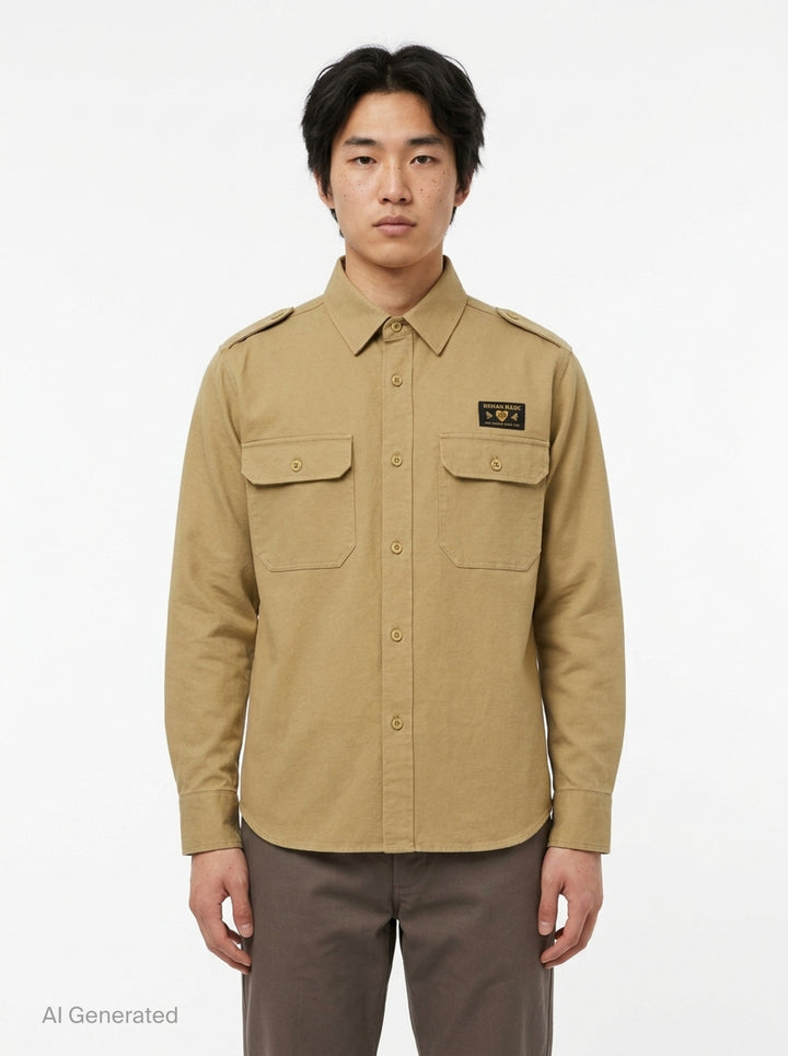 Human Made Twill Epaulette Long Sleeve Shirt in khaki cotton twill, featuring epaulette shoulders, twin flap chest pockets, button-down front placket, and a woven Human Made branding patch on the chest - front