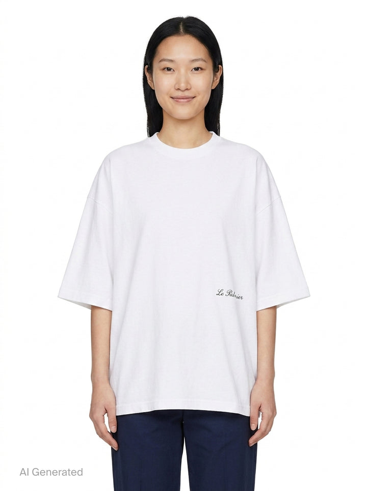 Jacquemus Le Palmier oversized white cotton tee with drop shoulders and 'Le Palmier' script embroidery at the hem, product flat lay - front