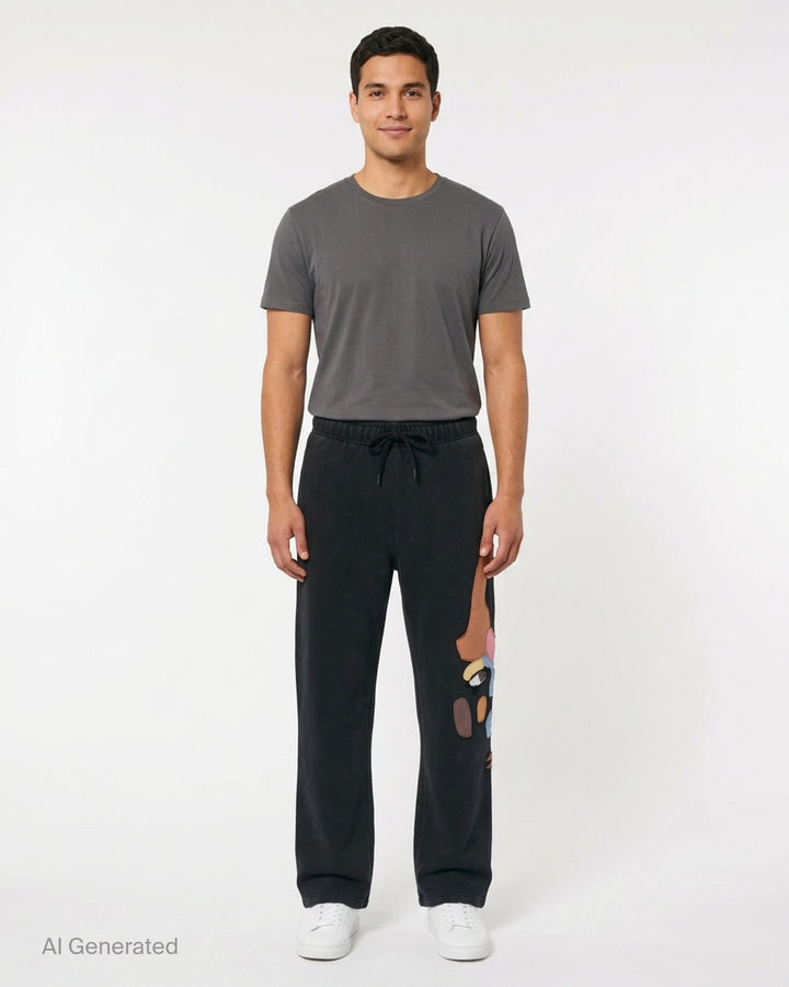 KidSuper Studios Side Eye Face washed black sweatpants with colourful patchwork appliqué face and drawstring waist - front