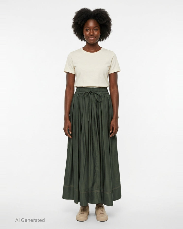Lee Mathews Sloane Pleat Midi Skirt in deep forest green, featuring a smocked elastic waistband with drawstring tie, voluminous gathered pleats, and contrast hem stitching - front