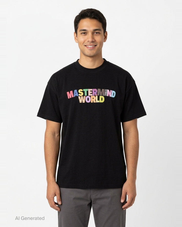 Mastermind World black boxy short sleeve tee with multicolour plaid-patterned arched logo wordmark printed across the chest - front