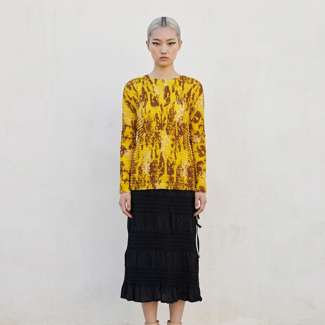 me Issey Miyake Leaf Pleats long sleeve crew neck top in yellow with tan and cream abstract print, shown flat against a white background - lifestyle