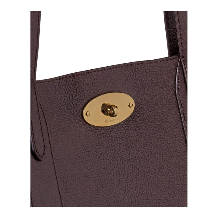 Mulberry Bayswater Small Tote in deep oxblood pebbled leather with twin flat shoulder straps and gold oval postman's lock hardware, front view on neutral background - packshot