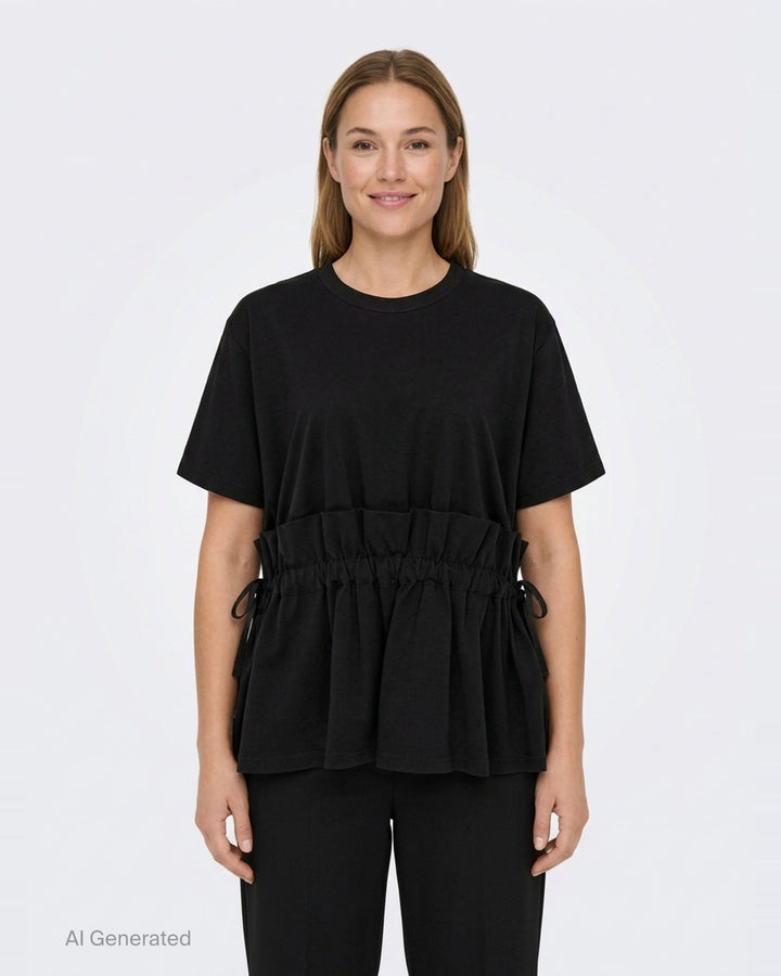 Noir Kei Ninomiya black short-sleeve cotton peplum tee with ruched gathered waistband, drawstring self-ties, and a tiered flared hem, shown flat on a white background - front