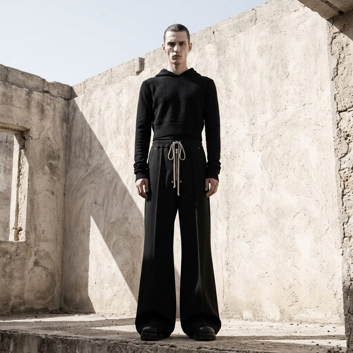 Rick Owens black cropped knit hoodie with fitted silhouette, ribbed hem and long sleeves, shown flat against a white background - lifestyle