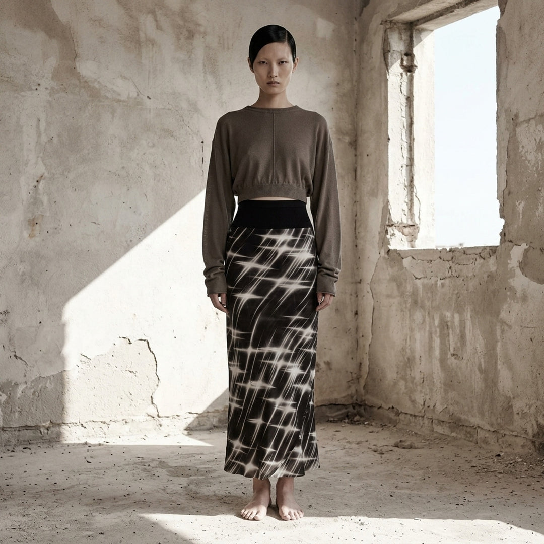 Rick Owens calf-length bias skirt in black with a white starburst print, ribbed black waistband and curved slit at the hem - lifestyle