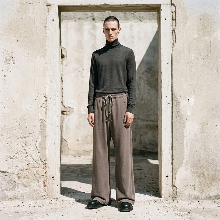 Rick Owens Wide Bela Pants in taupe grey with elasticated drawstring waist, zip-front detail and wide-leg silhouette, shown from the front - lifestyle