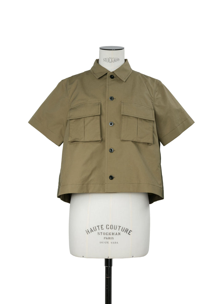 sacai khaki cropped boxy cotton weather short sleeve shirt with flap cargo pockets and swing back, shown on a dress form against a white background