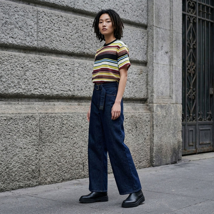 sacai x Levi's wide-leg mid-wash blue jeans with layered waistband and integrated webbing belt, shown flat from the front - lifestyle