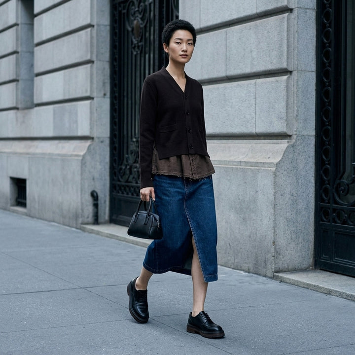 sacai washed black midi denim skirt with high waist, vertical front seam, five-pocket construction, copper rivets, and asymmetric hem slit - lifestyle