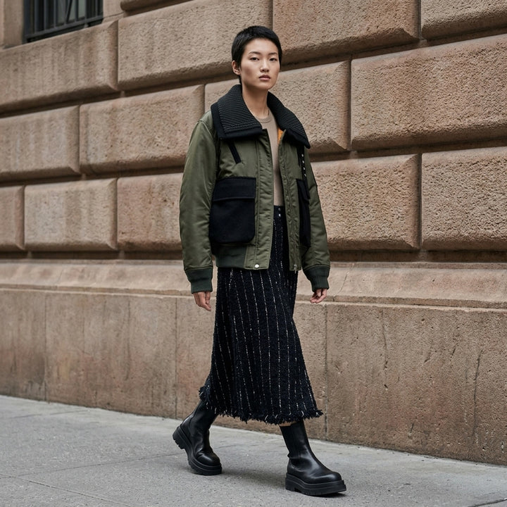 sacai Nylon Twill x Wool Melton Blouson in olive green, featuring an oversized ribbed knit collar, contrast black wool patch pockets, eyelet hardware detail, and orange satin lining at the collar reverse - lifestyle