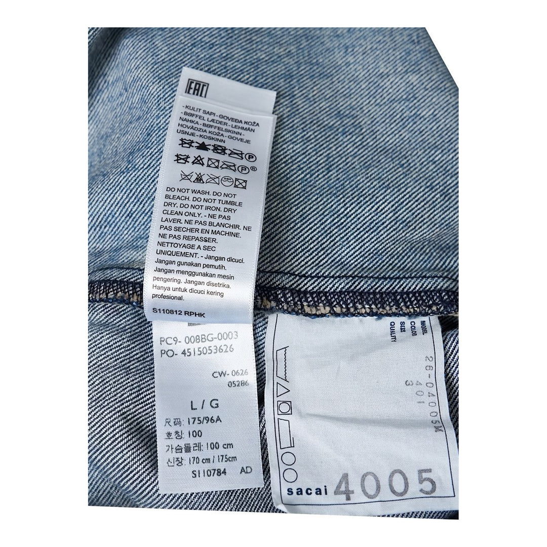 sacai Holiday Capsule mid-blue denim blouson with brown sherpa collar, cuffs and hem, an oversized leather front pocket and buckled side straps - packshot