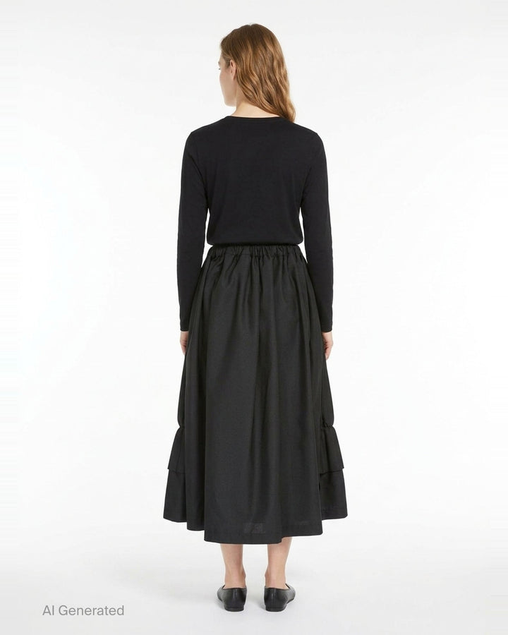 Tao black layered pleated midi skirt with elasticated waist, vertical pleats, gathered mid-section, and double-tiered ruffled hem, displayed on white background - back