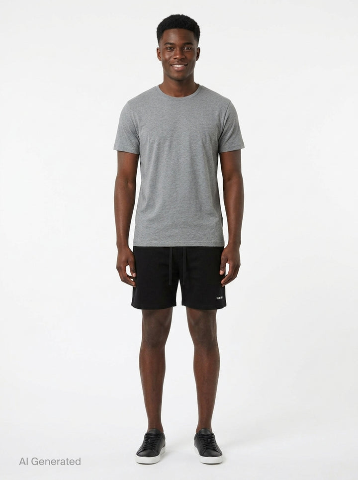 TEAM WANG design Original 1 Track Shorts in black, featuring an elasticated drawstring waistband and tonal logo print at the hip, shown flat against a white background - front