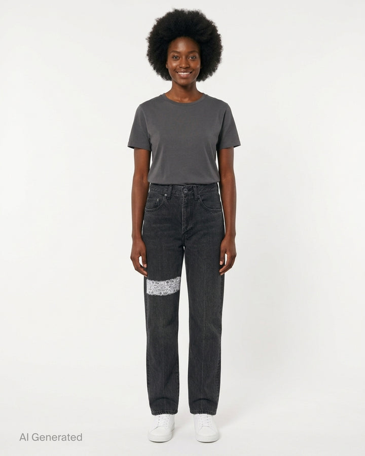 Undercover washed black straight-leg jeans with a white floral lace strip across the knee, shown from the front - front