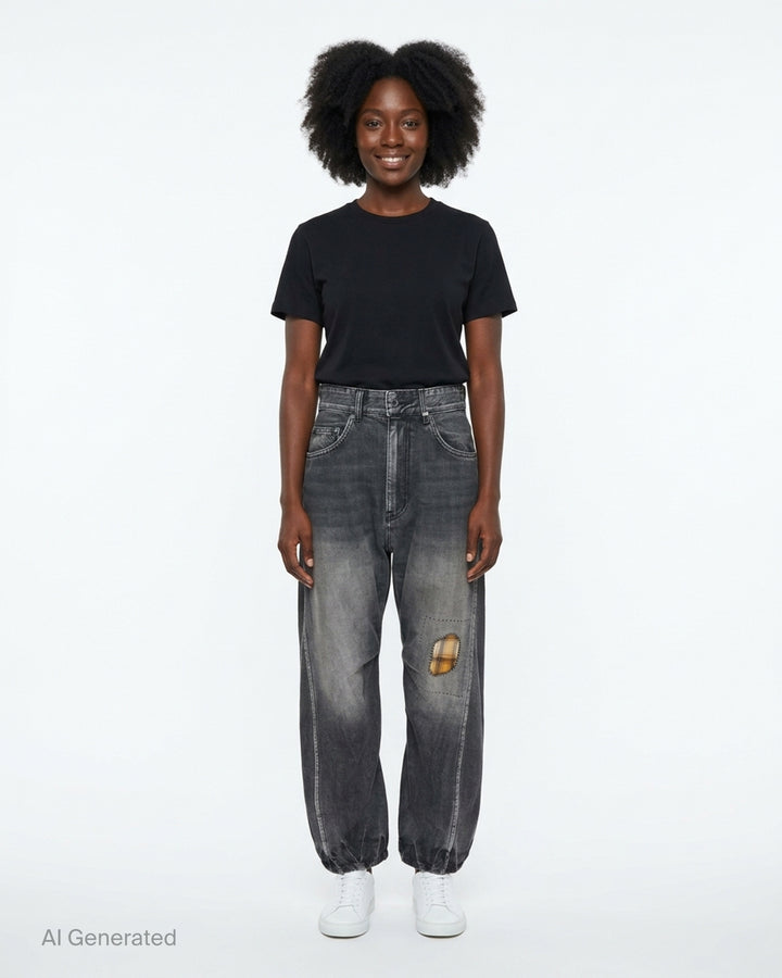 We11done washed grey curved jeans with a hand-stitched plaid check patch at the knee, five-pocket construction, and elasticated ankle cuffs - front