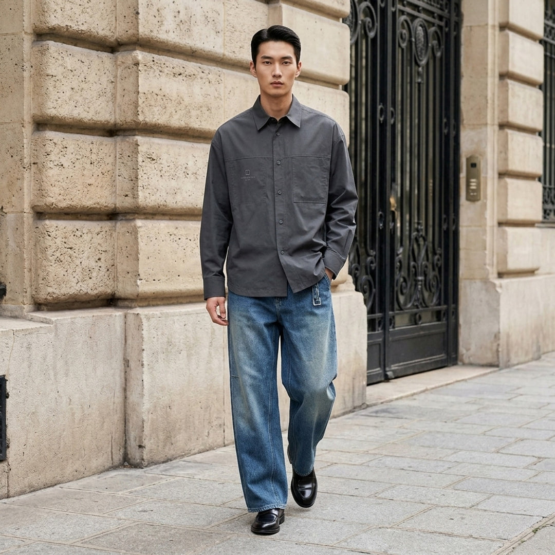 Wooyoungmi wide-leg denim pants in faded black wash with elasticated waistband and articulated knee seam detailing, front view on white background - lifestyle